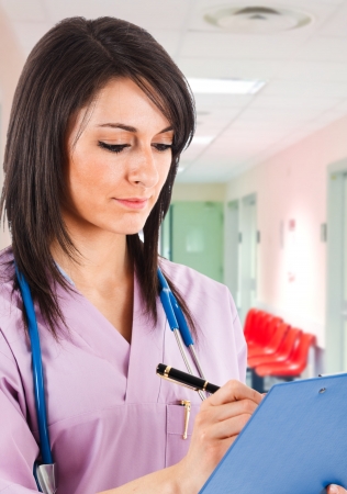 Portrait of a nurse writing notesの写真素材