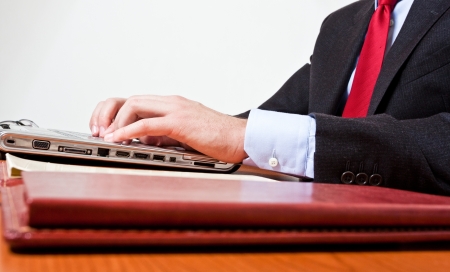 Close-up of a worker using a laptop computerの写真素材