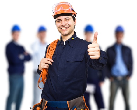 Portrait of an happy worker in front of his teamの写真素材