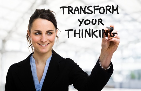 Businesswoman writing a motivational concept on the screenの写真素材