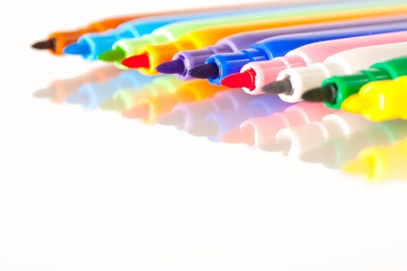 Colourful drawing pens on a white background