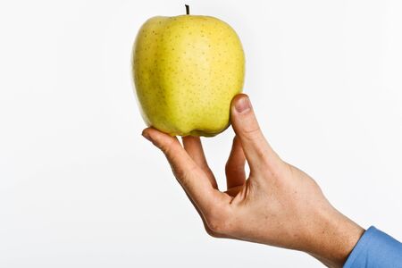 Hand showing an appleの写真素材