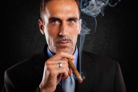 Portrait of a confident man smiking a cigarの写真素材