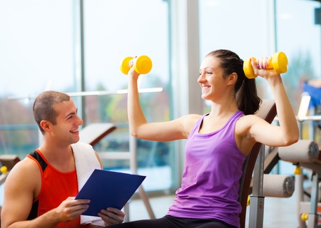 Personal trainer explaining an exercise to a woman