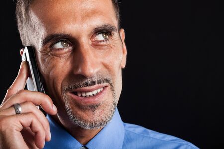 Portrait of a smiling businessman talking on the phone