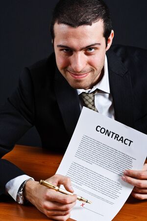 Dishonest businessman asking for your signature on a contractの写真素材