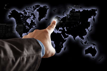 Businessman touching an electronic world map