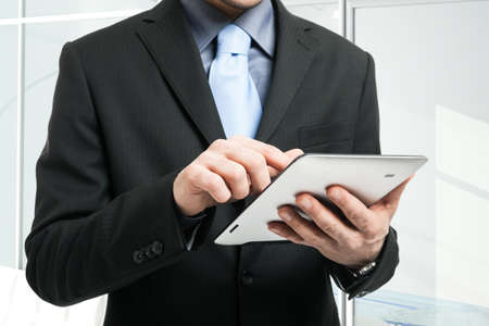 Close-up of a man holding a tablet pc