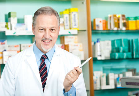 Portrait of a pharmacist at work in his shopの写真素材