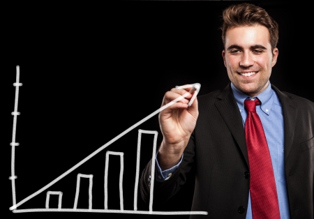 Man drawing a chart on the screen using a chalkの写真素材