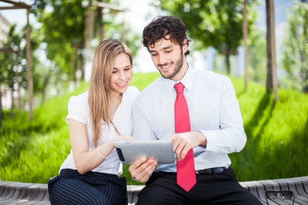 Business people using a digital tabletの写真素材