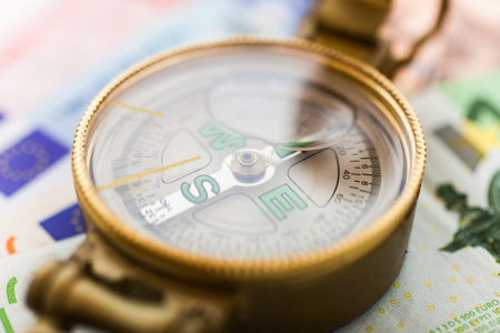 Compass over euro banknotesの写真素材