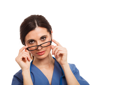 Portrait of a beautiful doctor holding eyeglassesの写真素材