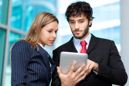 Business people using a digital tabletの写真素材