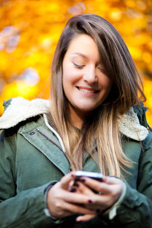 Young woman sending a sms