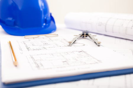 Compass, pencil and an helmet on a construction projectの写真素材