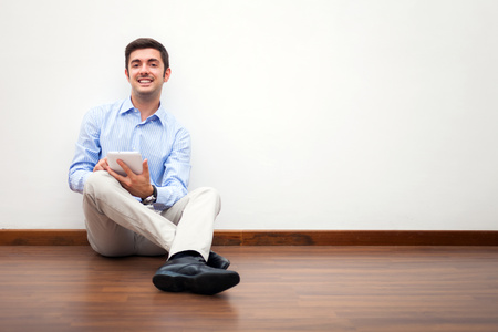 Smiling man using a digital tabletの写真素材