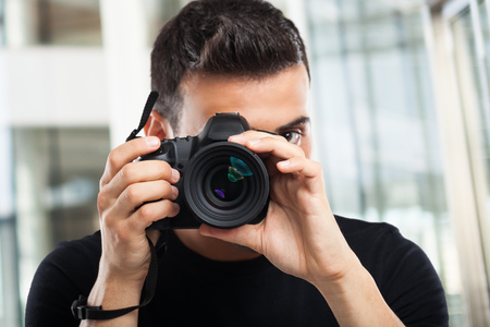 Photographer using his cameraの写真素材