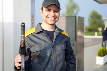 Smiling gas station attendant at workの写真素材