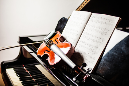 Classical music concept: cello, violin, piano and a scoreの写真素材