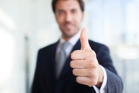 Portrait of a smiling businessman giving thumbs upの写真素材