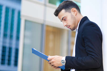 Young business man reading a documentの写真素材