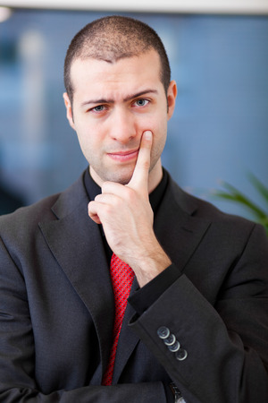 Doubtful businessman portraitの写真素材