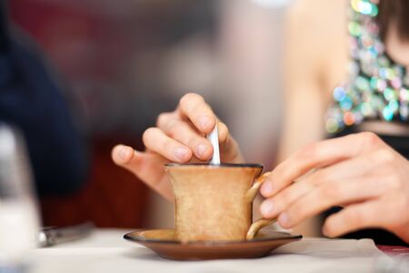 Woman preparing to drink an espressoの写真素材