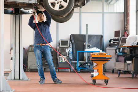 Portrait of a mechanic at work in his garage