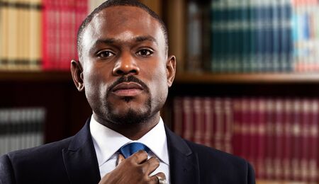 Mature businessman adjusting his tieの写真素材