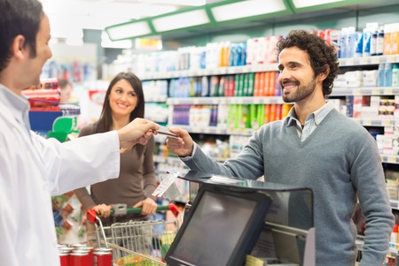 Customer using a credit card to pay in a supermarket