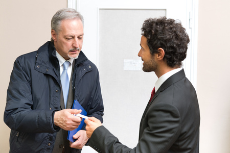 Businessman giving his business card to a customer