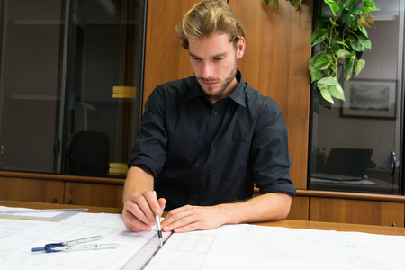 Portrait of an engineer working on a project in his office
