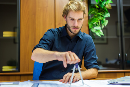 Portrait of an engineer working on a project in his office