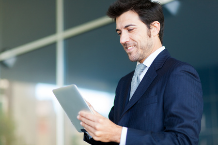 Handsome man using his tablet computerの写真素材