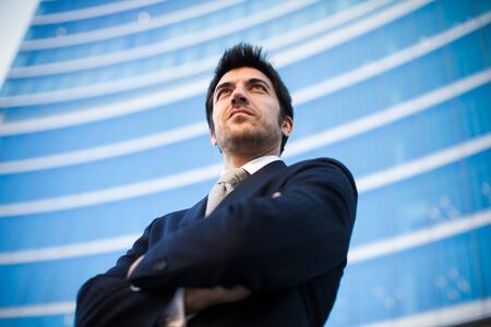 Portrait of a confident business man in front of a modern building