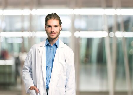 Portrait of an handsome smiling doctor portraitの写真素材