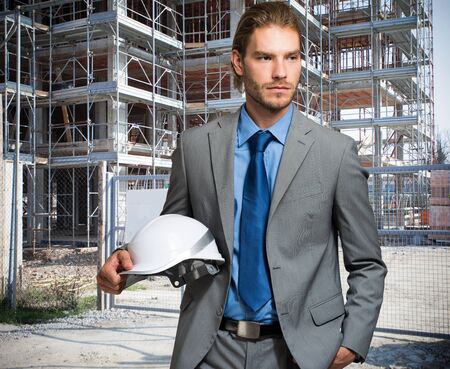 Portrait of an handsome engineer in front of a construction site
