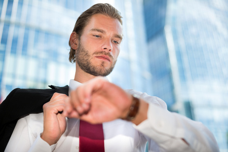 Handsome businessman looking at his watchの写真素材