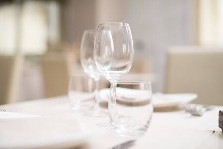 Glasses on a restaurant table. Very shallow depth of fieldの写真素材