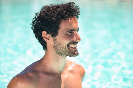 Portrait of a smiling young man relaxing in the waterの写真素材