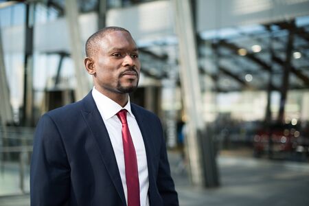 Portrait of an handsome businessman walking in a business environmentの写真素材