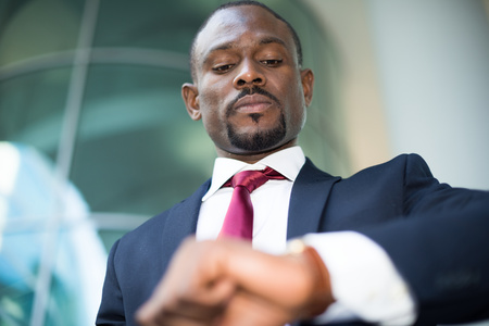 Handsome businessman looking at his watchの写真素材
