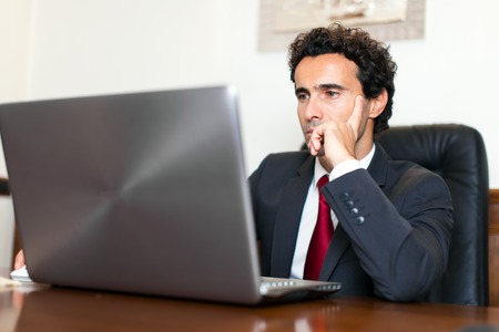 Businessman using a computer in his officeの写真素材