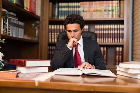 Portrait of a businessman reading a bookの写真素材