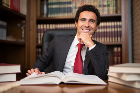 Portrait of a man in front of a bookの写真素材