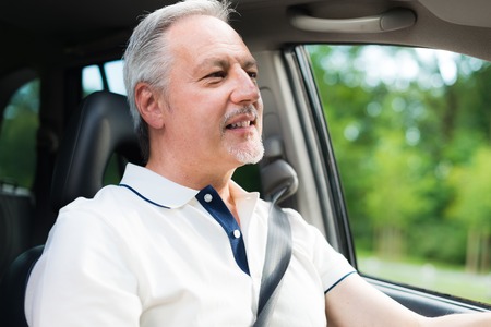 Smiling man driving his carの写真素材