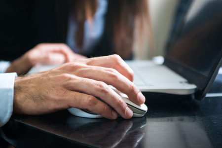 Detail of a person using his laptop computer