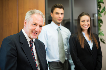 Portrait of a businessman in front of his colleagues