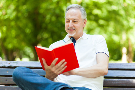 Mature man reading a bookの写真素材